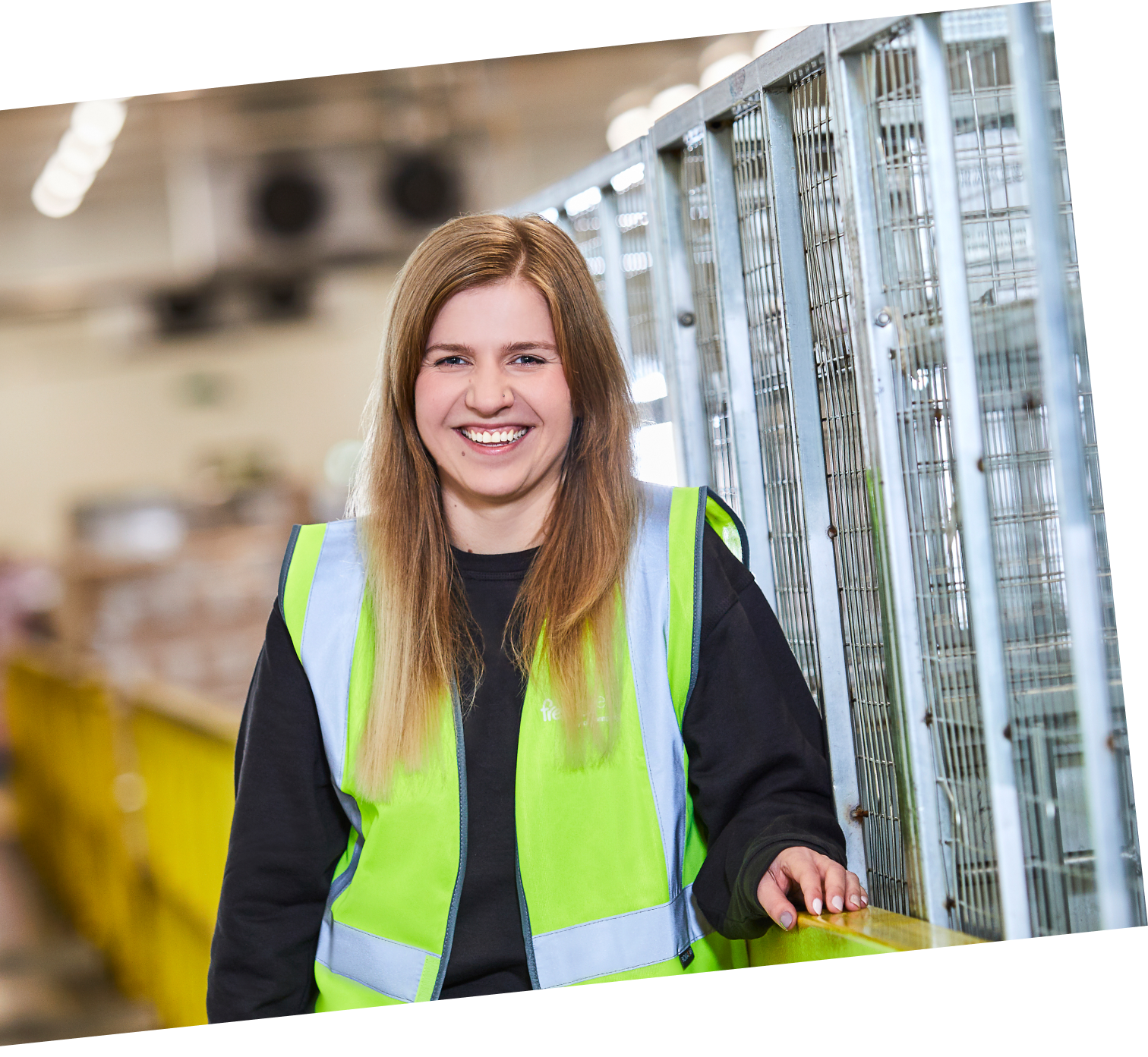 Smiling warehouse staff in hi-vis.