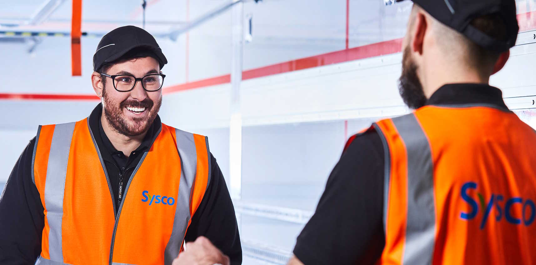 Worker with trolley in warehouse.